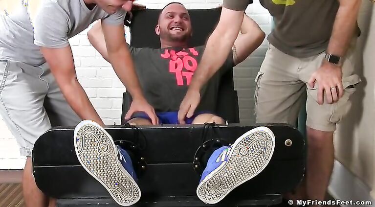 Julian Knowles is restrained and tickled by two kinky studs